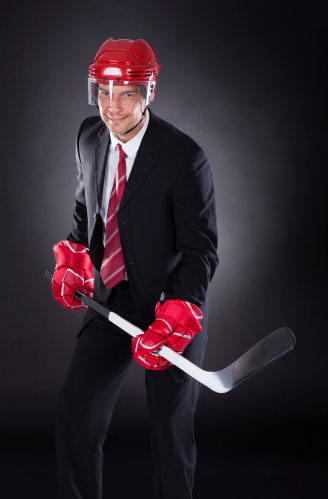 man in suit with hockey stick